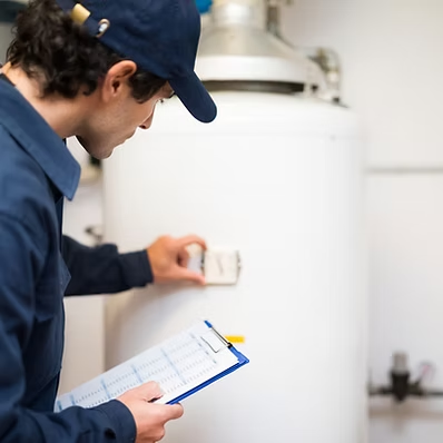 Technician inspecting mechanical system for radon mitigation